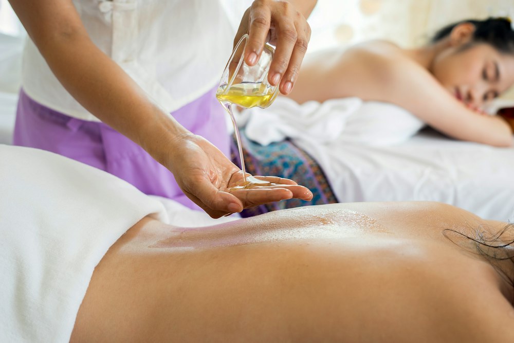 Luxury spa ritual with warm stones, aromatic botanical oils and soothing massage